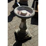 A classical style reconstituted stone bird bath