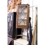 A mahogany corner cabinet