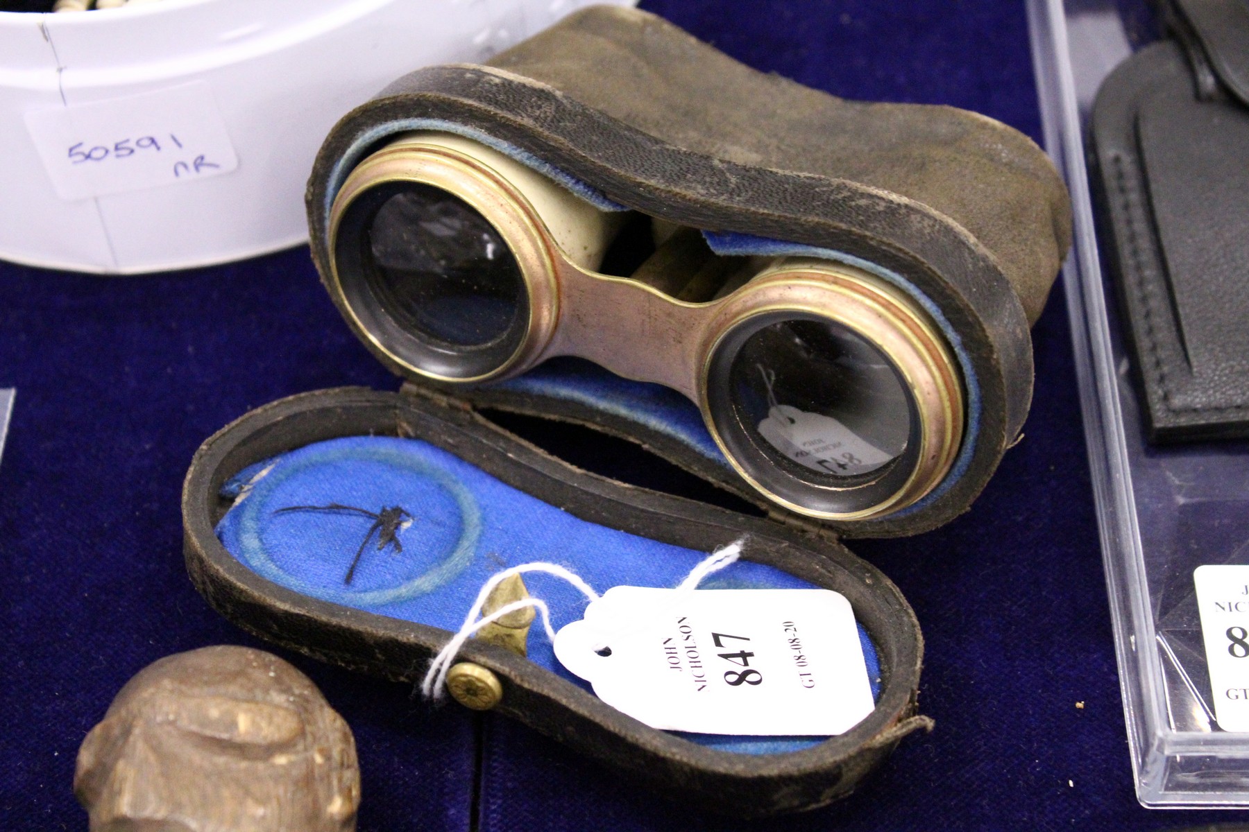 A cased pair of opera glasses