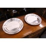Two plated circular dishes one embossed with leaves