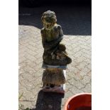 A reconstituted stone cherub fountain on a pedestal base