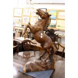 A large and impressive carved wood model of a rearing horse