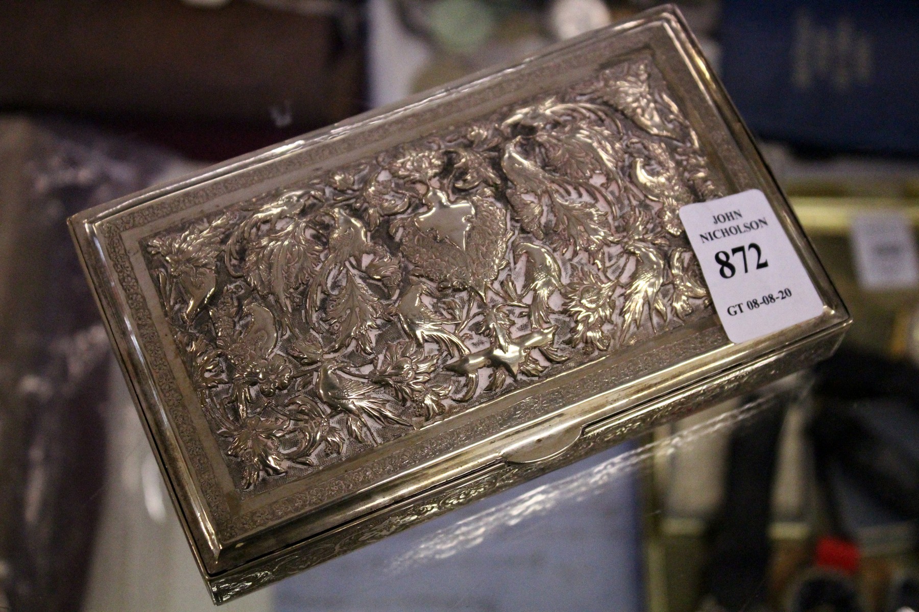 A good Eastern silver box with embossed hinged lid and engraved decoration