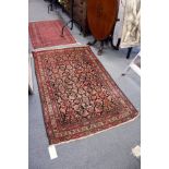 A Persian rug with stylised decoration