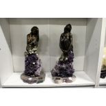 A pair of unusual bronze and amethyst figurines