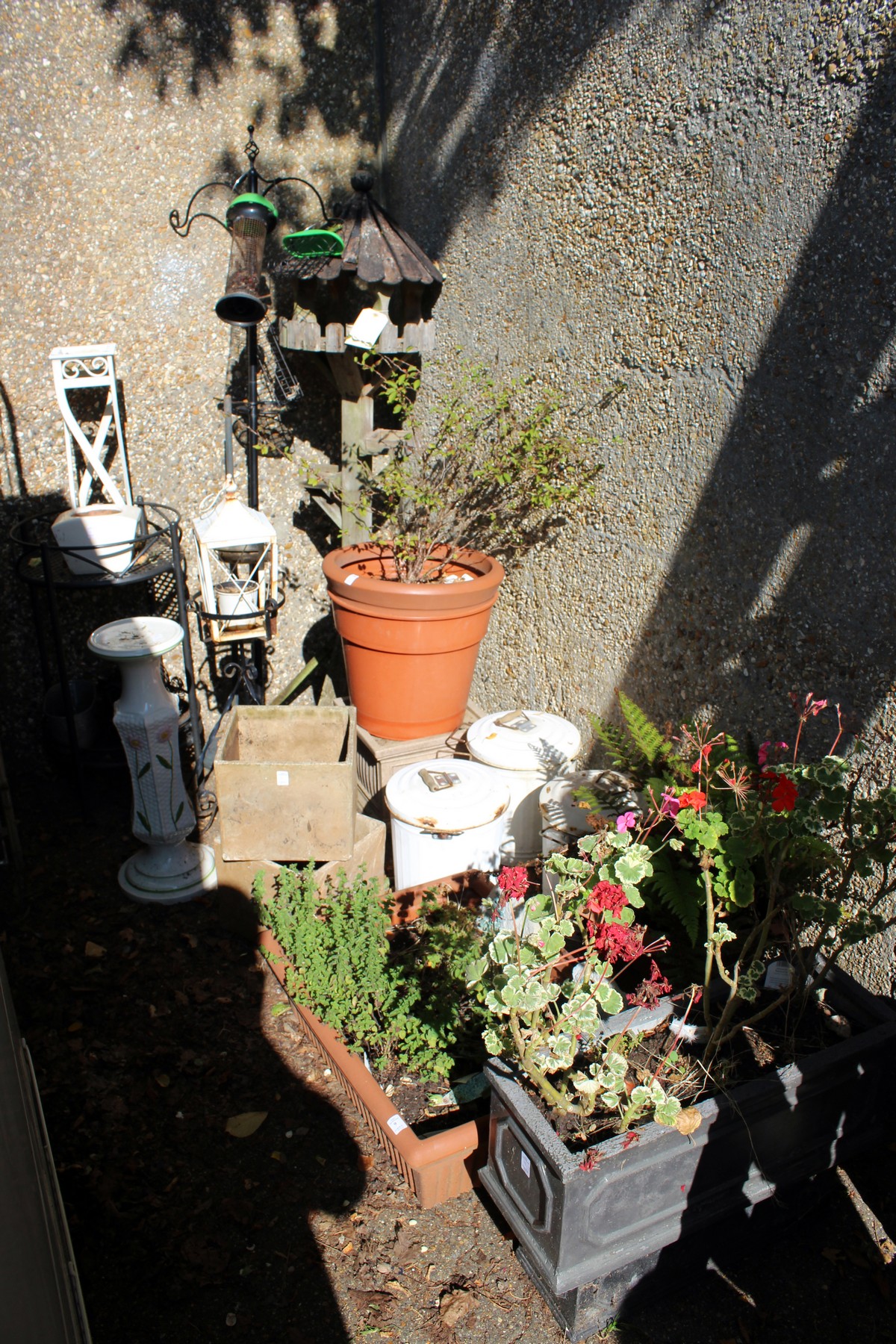 A quantity of garden planters, plants, bird table etc, etc