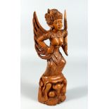 A carved wood tai figure