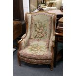 A pair of French style carved walnut framed armchairs with floral upholstery