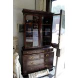 Maple and Co A good quality mahogany bookcase on chest with carved frieze pair of glazed doors,