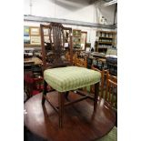 A set of four Hepplewhite revival carved mahogany framed dining chairs with overstuffed seats