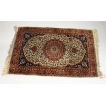 A small beige ground Persian rug