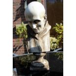 A garden ornament modelled as a bust of a bald headed man