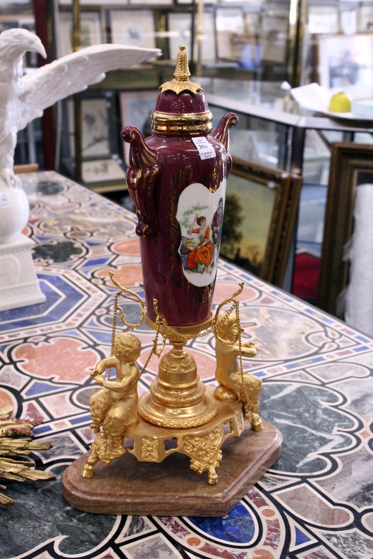A pair of impressive continental ormolu marble and porcelain urns on stands