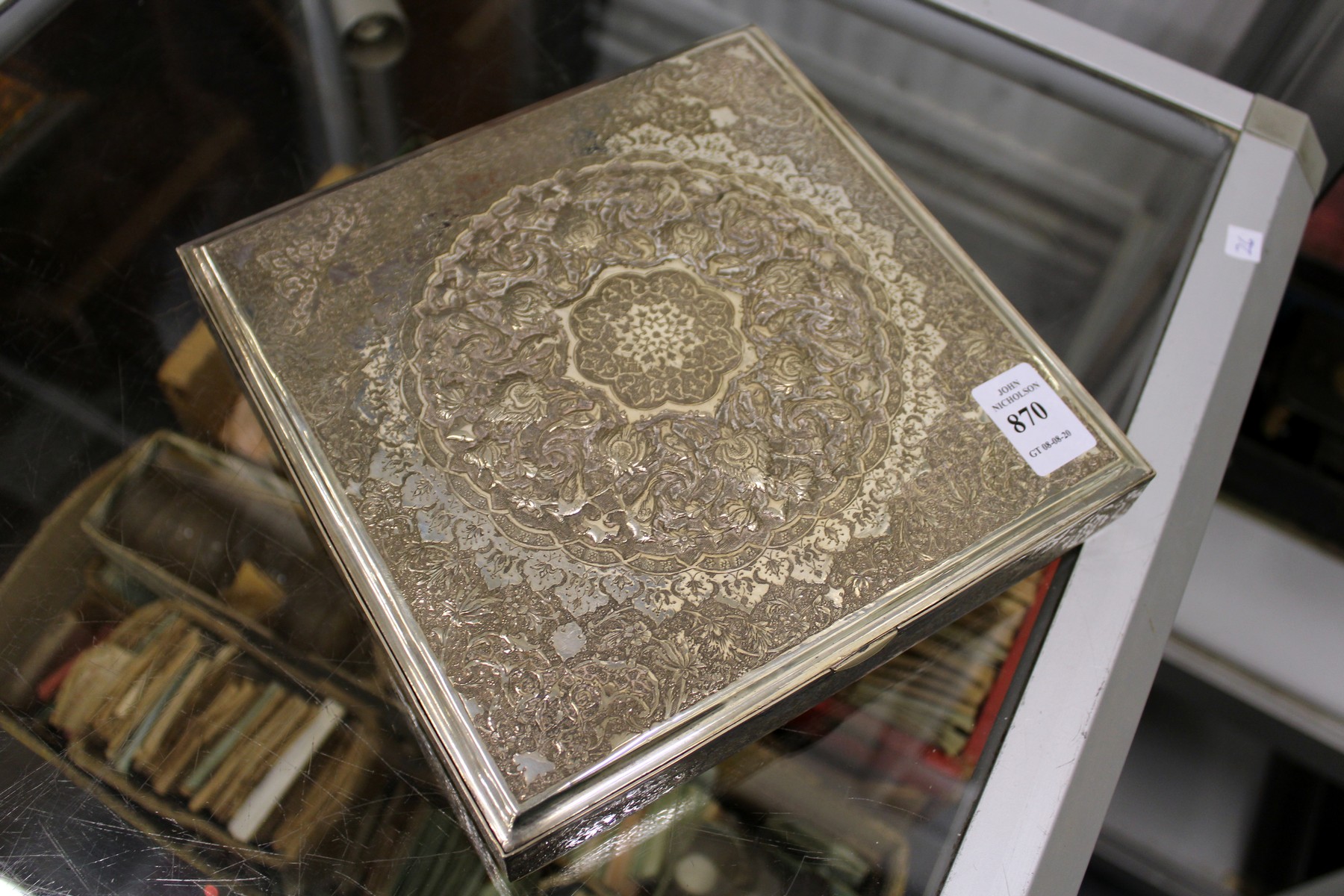 A good Eastern silver square shaped box with hinged cover having ornate embossed decoration