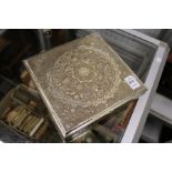A good Eastern silver square shaped box with hinged cover having ornate embossed decoration