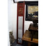 A good large pair of Chinese red lacquer framed narrow mirrors with carved decoration