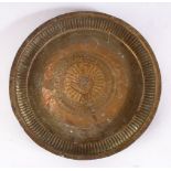 A 19TH CENTURY INDAIN BRASS CHARGER / DISH, with embossed decoration, 22.5cm.