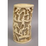 A 19TH CENTURY CHINESE CARVED IVORY OPENWORK TUSK SECTION, carved to depict landscapes upon