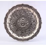 A CHINESE WHITE METAL DRAGON DISH, decorated with many dragons amongst clouds, 12cm.