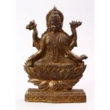 A GOOD INDIAN GILT BRONZE FIGURE OF BUDDHA, multi arm goddess seated, 28cm high.
