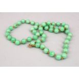 A GOOD SET OF APPLE GREEN CHINESE JADE BEADS, 66CM.