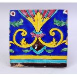 A 19TH CENTURY PERSIAN QAJAR GLAZED POTTERY TILE, with polychromed decoration, 19.5cm wide.