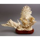 A FINE QUALITY JAPANESE MEIJI PERIOD CARVED IVORY OKIMONO - TWO PEACOCKS, finely depicted one with