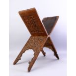 A GOOD ISLAMIC CARVED WOODEN QURAN STAND, carved with foliate decoration, closed, 76cm high x 26cm