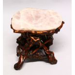 A GOOD CHINESE ROSE QUARTZ TOPPED LOW TABLE, the base formed from naturalistically carved wood