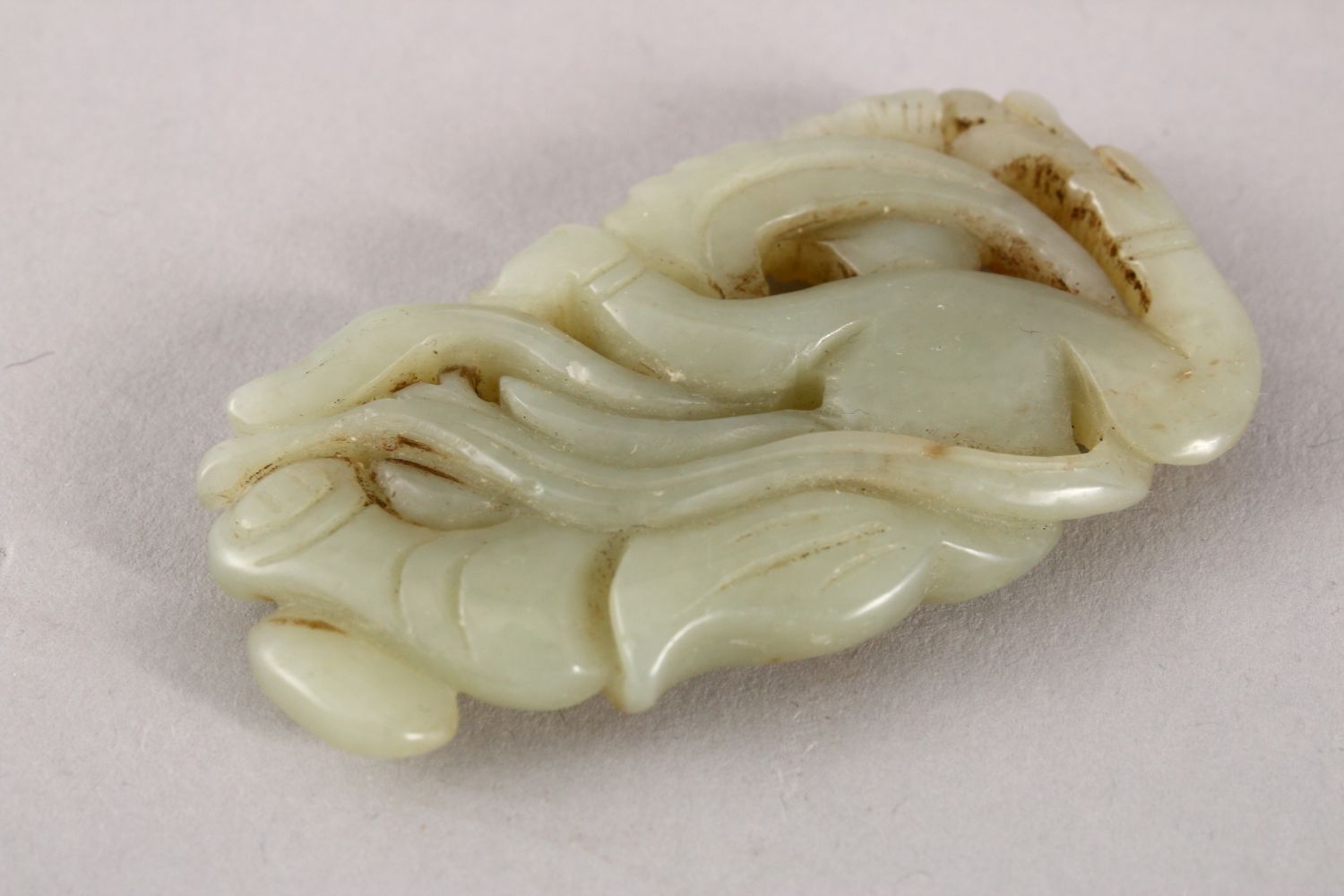 A GOOD 19TH / 20TH CENTURY CHINESE CARVED CELADON JADE PENDANT OF A GODDESS, the goddess recumbent - Image 2 of 2