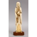 A 19TH CENTURY CHINESE CARVED IVORY FIGURE OF A SCHOLAR, 20cm.