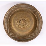 A 19TH CENTURY INDAIN BRASS CHARGER / DISH, with embossed decoration, 25cm