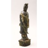 A 20TH CENTURY CHINESE CARVED JADE FIGURE OF GUANYIN, stood upon a stylized stump base holding a