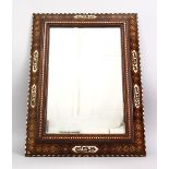 A 19TH CENTURY SPANISH MORESQUE INLAID CALLIGRAPHIC WOODEN MIRROR, the frame with exotic wood inlay,