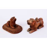 TWO 19TH CENTURY INDIAN MAYSORE CARVED SANDALWOOD FIGURES OF RECUMBENT LIONS, one on a rectangular