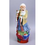 A GOOD 19TH / 20TH CENTURY CHINESE FAMILLE ROSE PORCELAIN FIGURE OF SHOU LAO, stood holding his