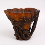 A GOOD 19TH / EARLY 20TH CENTURY CHINESE RHINO HORN LOIBATION CUP, the cup carved with pine tree