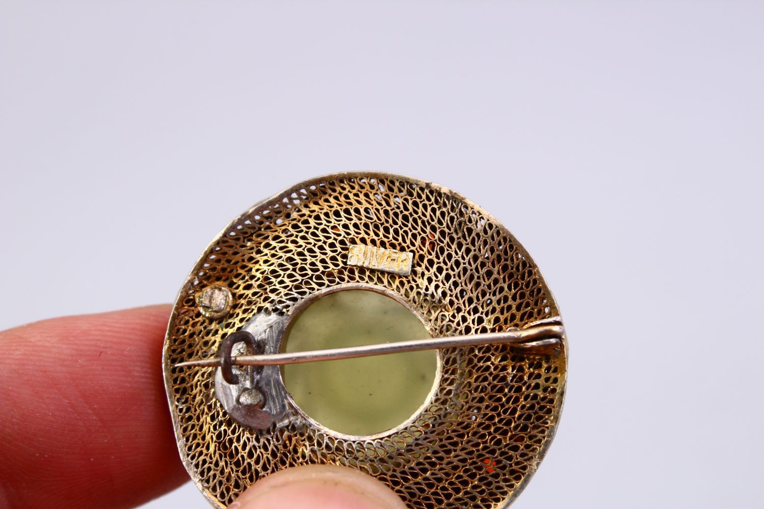 A GOOD INDIAN SILVER GILT & JADE BROOCH, with filigree work enclosing a floral carved jade centre, - Image 4 of 4