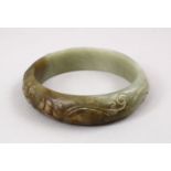 A GOOD CHINESE CARVED JADE BANGLE, carved with chilong, 7cm.