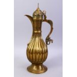 A GOOD BOKHARA SAFAVID BRASS EWER, with ribbed body, openwork cover, and turquoise inlaid handle,
