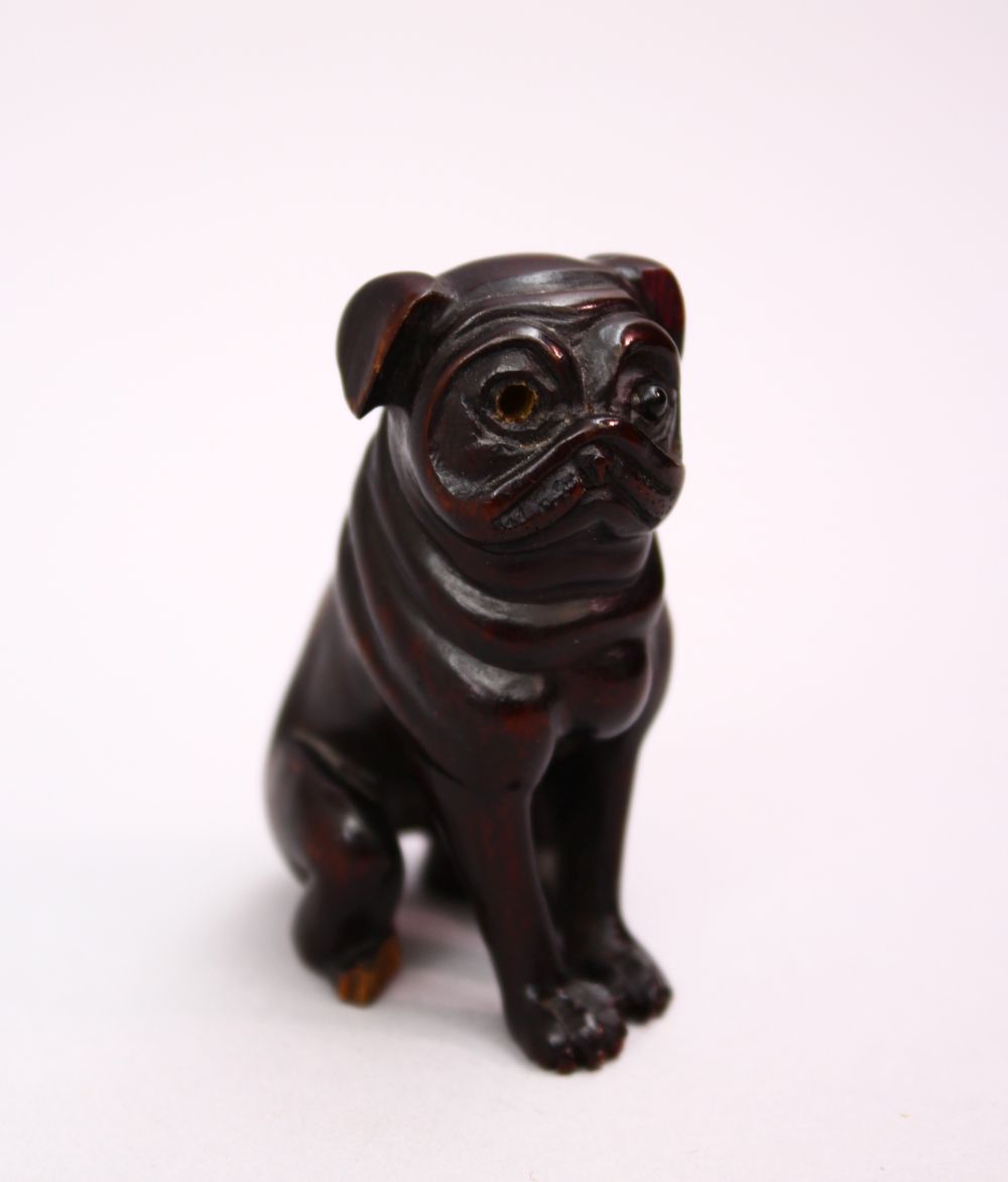 A JAPANESE MEIJI STYLE CARVED WOODEN NETSUKE OF A DOG, Signed, 5cm.