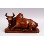 A GOOD 19TH CENTURY CHINESE CARVED HARDWOOD FIGURE OF A RECUMBENT BUFFALO, 32cm.