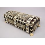AN INDIAN EBONY AND IVORY DOMED SHAPED CASKET AND COVER, on claw feet, 10ins long.