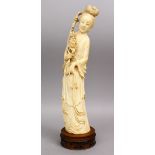 A 19TH CENTURY CHINESE CARVED IVORY FIGURE OF GUANYIN, holding a bouquet, 36cm high.
