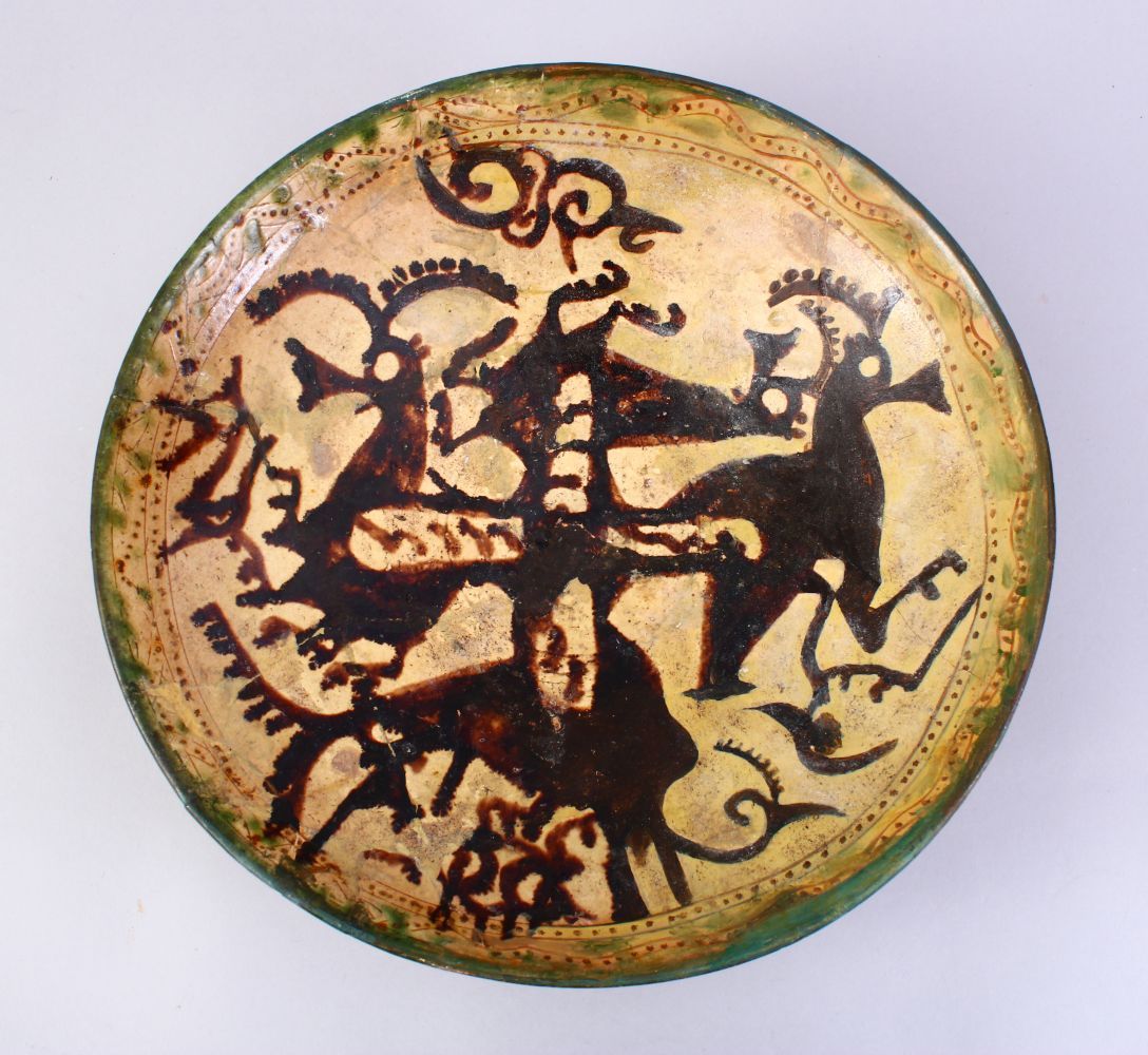 A GOOD EARLY ISLAMIC POTTERY DISH, decorated with animals, 33cm, AF