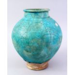 A GOOD EARLY ISLAMIC TURQUOISE GLAZED POTTERY VASE, with carved floral decoration, 27cm high.