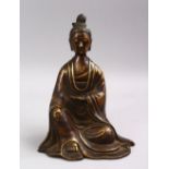 A CHINESE BRONZE FIGURE OF GUANYIN, in a seated position, 23cm high.