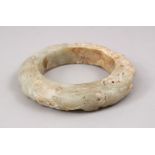 A LARGE CHINESE CARVED JADE ARCHAIC FORM BANGLE, 10CM.