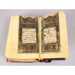 AN EARLY LEATHER BOUND COPY OF THE QURAN, 6 ins x 4 ins.