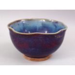 A GOOD CHINESE JUN WARE PORCELAIN MOULDED BOWL, with graduating colour glaze, 16.5cm diameter.